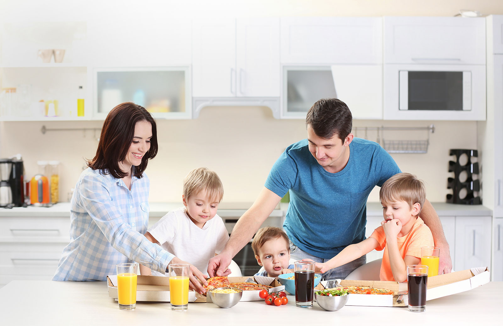 Family sitting around the kitchen table; TRICOR home insurance