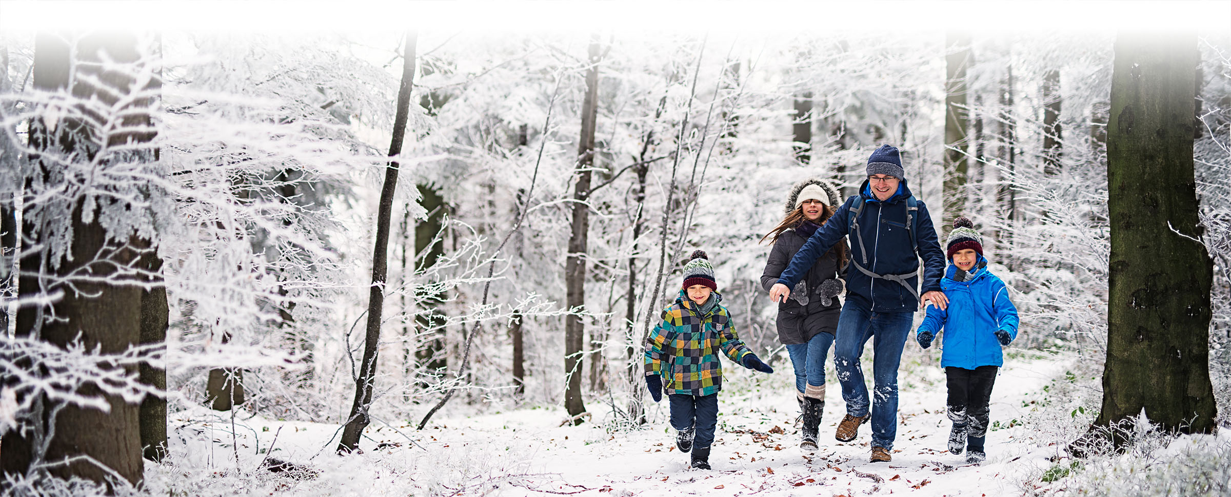 Family hiking in a snowy forest